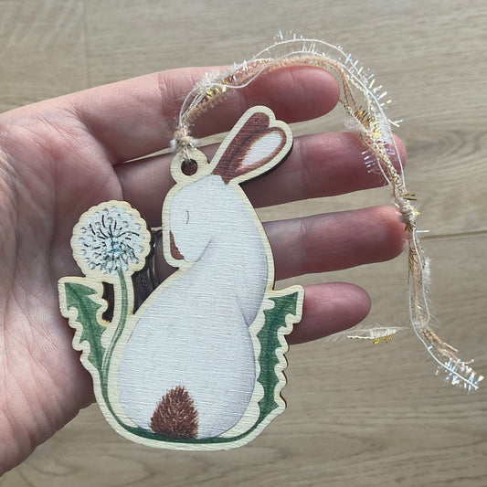Hanging wooden rabbit decoration printed on birch wood titled My Heart is Yours featuring a whimsical bunny looking at a red heart with textured hanging yarn