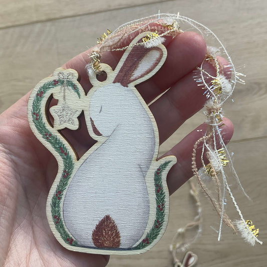 Festive Christmas rabbit wooden decoration printed on birch wood titled My Christmas Star featuring a white bunny under a pine garland with red berries and a gold star ornament