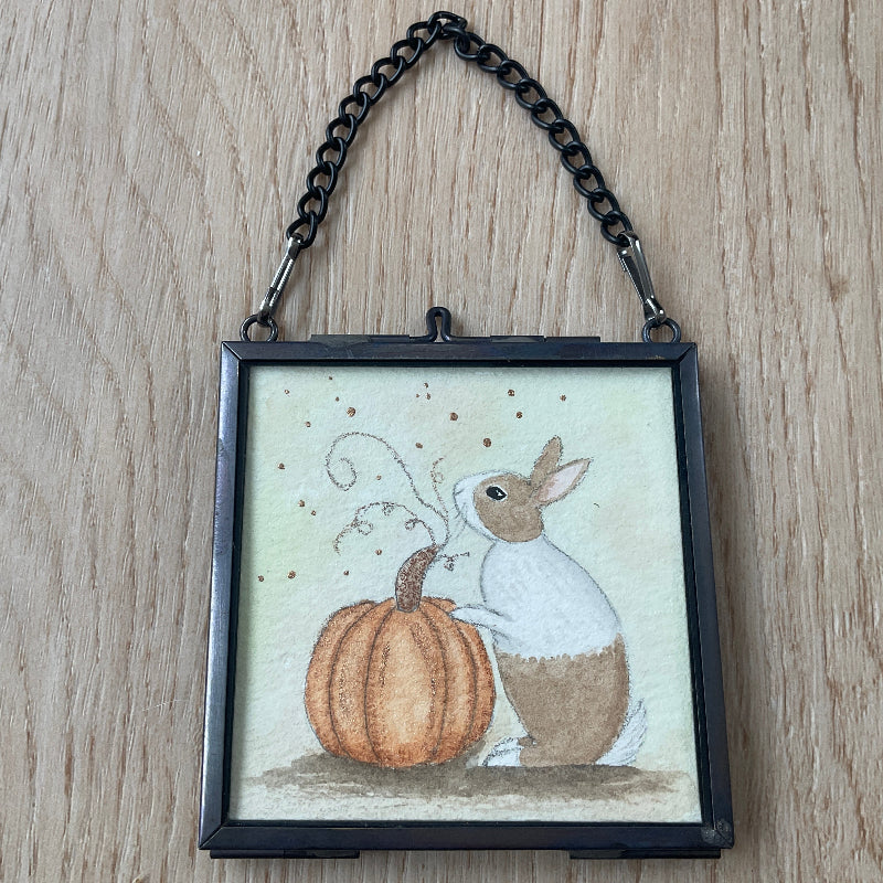 Original mini watercolor painting titled The Magic Pumpkin featuring a brown and white Dutch rabbit investigating a pumpkin vine.
