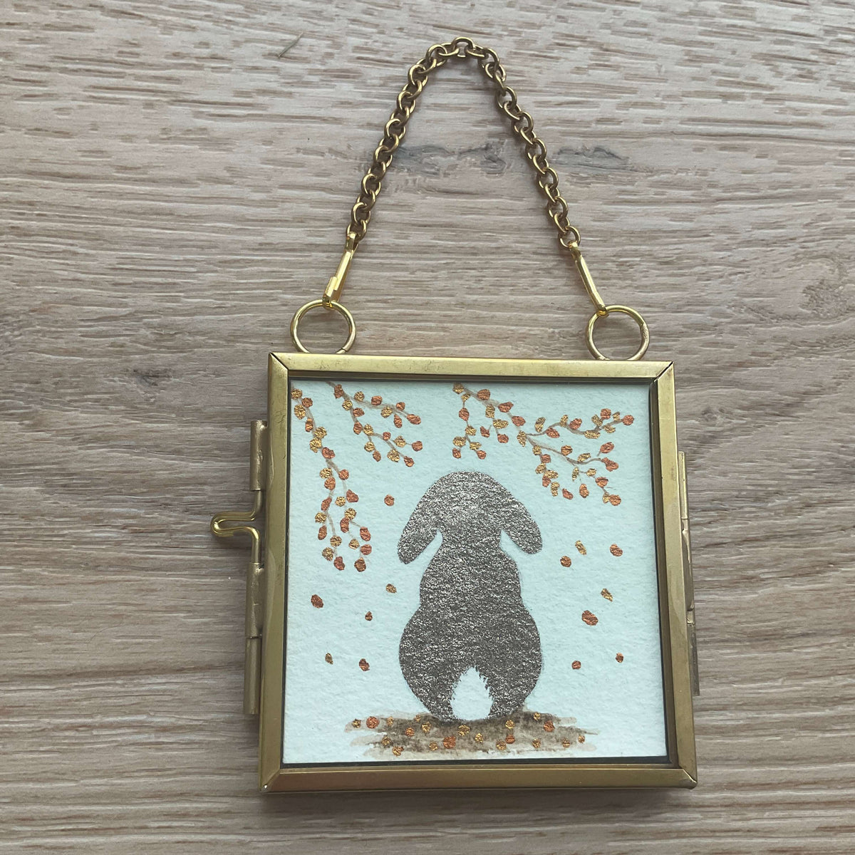 hispers of Autumn miniature lop-eared rabbit watercolor painting in a hanging square brass frame with a gold chain